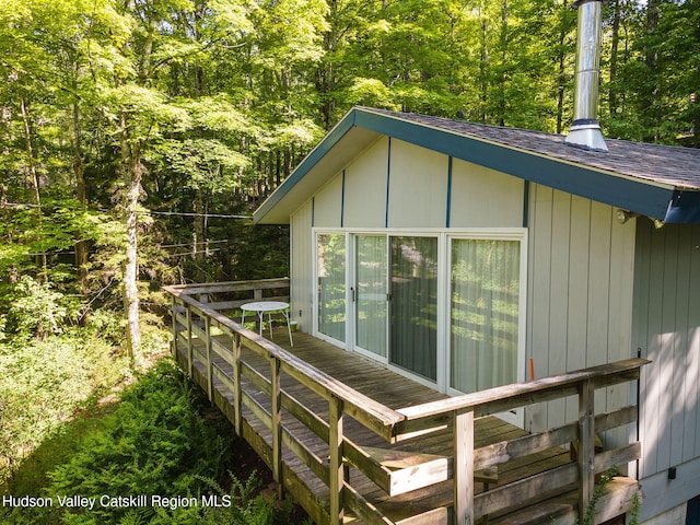 101 Hunter Ln, Hunter, NY 12442 - view of property exterior with a deck, a view of trees, and roof with shingles
