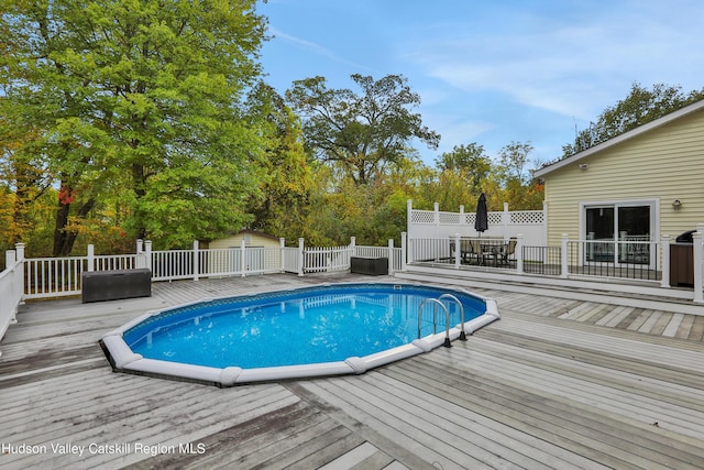 view of swimming pool featuring a wooden deck