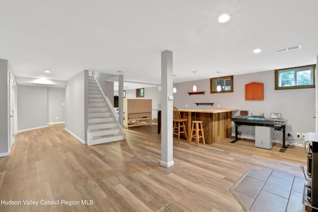 interior space featuring bar area and light wood-type flooring