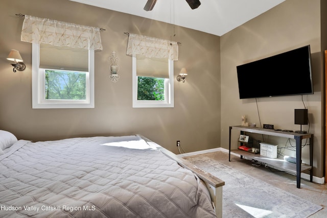 bedroom with carpet floors, multiple windows, and ceiling fan