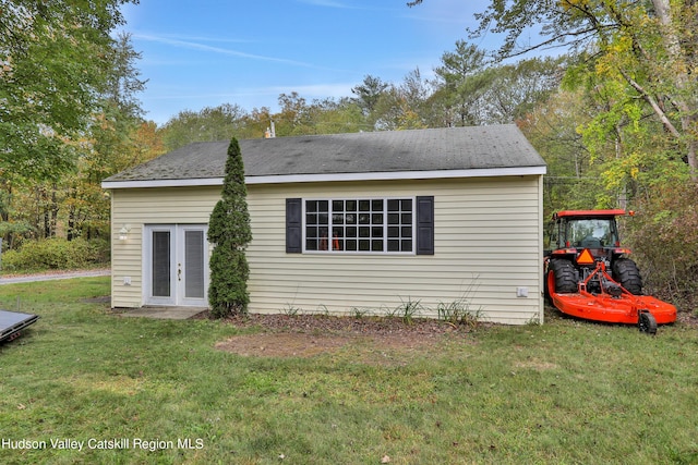 view of side of property featuring french doors and a yard