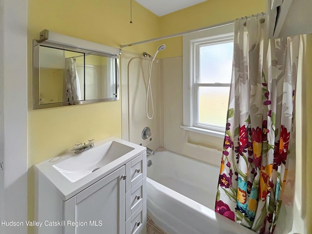 bathroom with vanity, a healthy amount of sunlight, and shower / bath combo