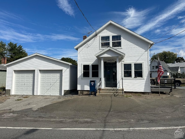 2 Hudson Ave, Stuyvesant, NY 12173 - view of front facade with entry steps, an outbuilding, a garage, and a chimney