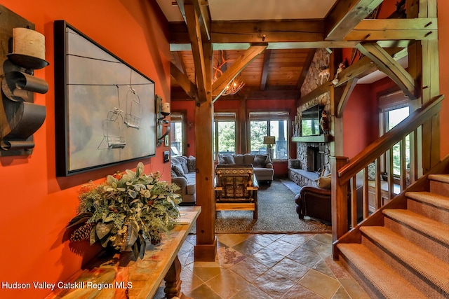 2 Watch Hill Ln Unit 2, Windham, NY 12496 - living room featuring a stone fireplace, stairs, stone tile floors, and wood ceiling
