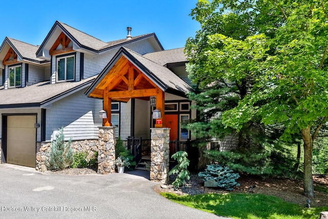 2 Watch Hill Ln Unit 2, Windham, NY 12496 - view of front of home with stone siding, a shingled roof, and an attached garage