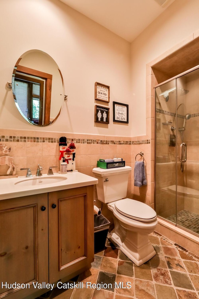2 Watch Hill Ln Unit 2, Windham, NY 12496 - bathroom with tile walls, vanity, a shower stall, and a wainscoted wall