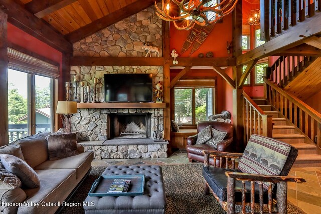 2 Watch Hill Ln Unit 2, Windham, NY 12496 - living area featuring a chandelier, plenty of natural light, a wood ceiling with exposed beams, a stone fireplace, and stairs