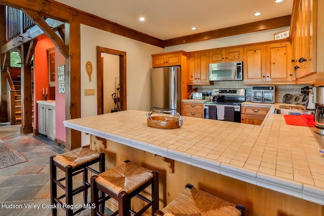 2 Watch Hill Ln Unit 2, Windham, NY 12496 - kitchen featuring stainless steel appliances, decorative backsplash, recessed lighting, a peninsula, and dark stone finish floors