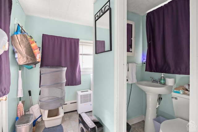 10-12 School St, Chatham, NY 12037 - bathroom featuring toilet, baseboards, baseboard heating, and a sink