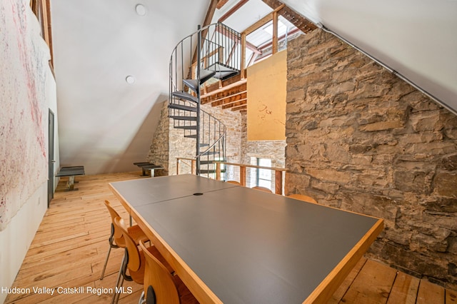 kitchen with light hardwood / wood-style floors and high vaulted ceiling