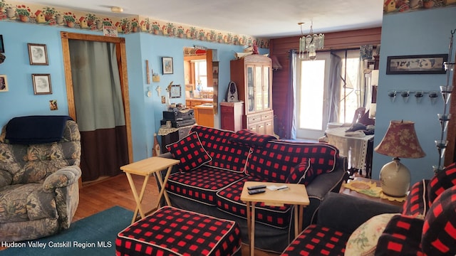 living area with a chandelier and wood finished floors