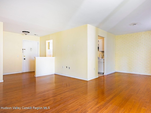902 Commons Way Unit B, Fishkill, NY 12524 - empty room featuring baseboards, light wood finished floors, and brick wall