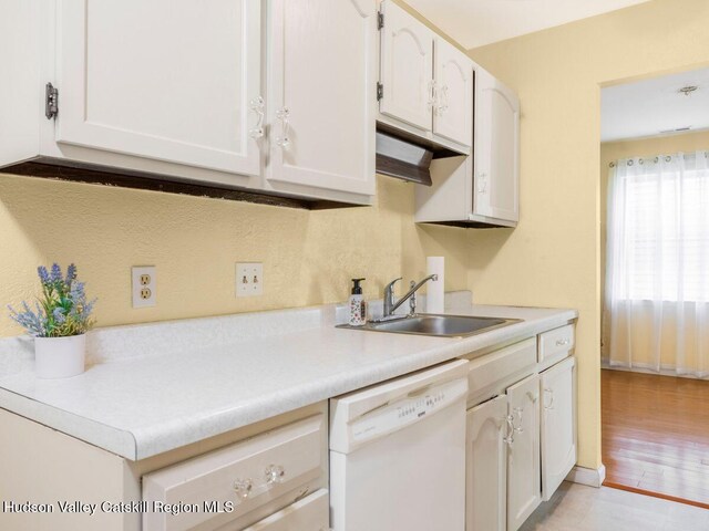 902 Commons Way Unit B, Fishkill, NY 12524 - kitchen with dishwasher, a sink, light countertops, light wood-style floors, and white cabinets