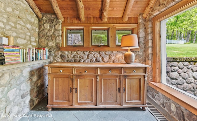 interior space with beamed ceiling and wooden ceiling