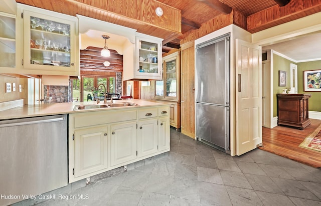 kitchen featuring ornamental molding, stainless steel appliances, sink, decorative light fixtures, and wooden ceiling