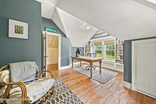 home office featuring wood-type flooring and lofted ceiling