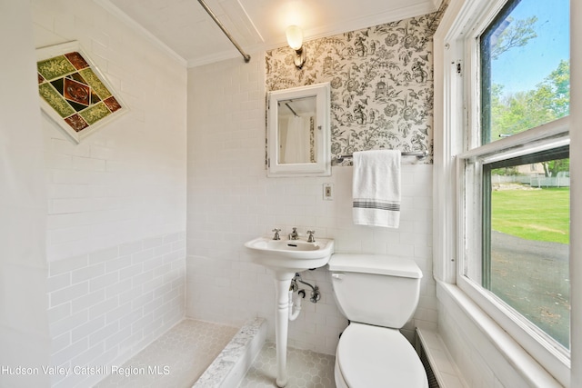 bathroom featuring ornamental molding and tile walls