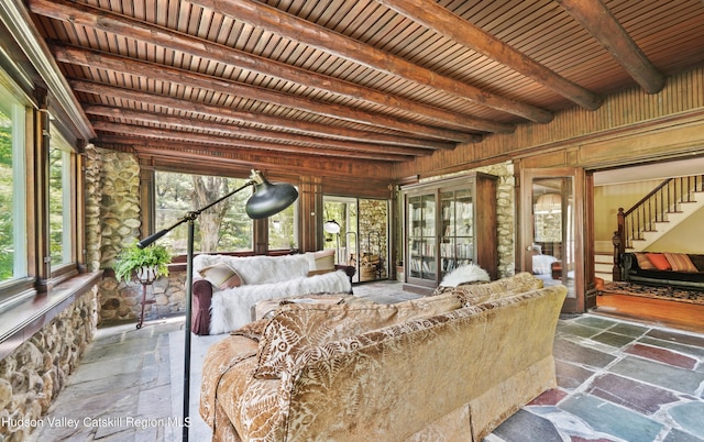 sunroom featuring beam ceiling and wood ceiling