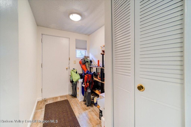 entryway featuring a textured ceiling and light hardwood / wood-style floors