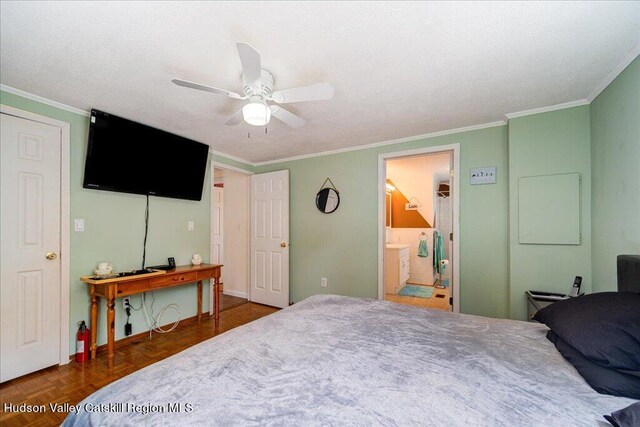 bedroom with ceiling fan, dark parquet flooring, ornamental molding, and ensuite bathroom