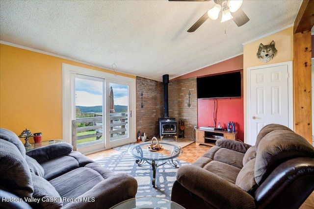 living room featuring lofted ceiling, a wood stove, a textured ceiling, and ornamental molding