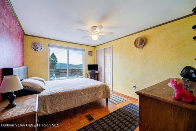 bedroom with parquet flooring, a closet, ceiling fan, and ornamental molding