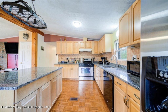 kitchen featuring light brown cabinetry, crown molding, sink, black appliances, and lofted ceiling