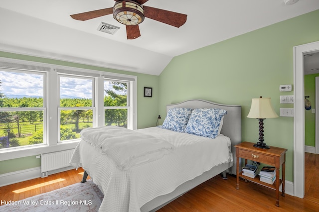 511 County Route 10, Germantown, NY 12526 - bedroom featuring radiator, lofted ceiling, baseboards, wood finished floors, and ceiling fan