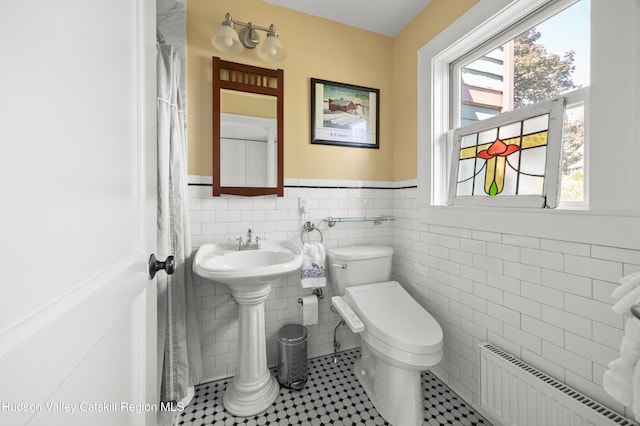 511 County Route 10, Germantown, NY 12526 - bathroom with radiator heating unit, wainscoting, toilet, healthy amount of natural light, and tile walls