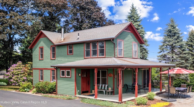 511 County Route 10, Germantown, NY 12526 - view of front of home with a shingled roof, a porch, and a patio