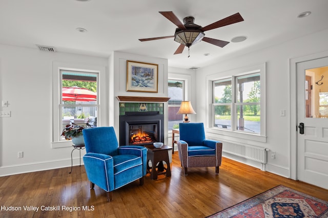 511 County Route 10, Germantown, NY 12526 - sitting room featuring radiator, a tile fireplace, healthy amount of natural light, wood finished floors, and recessed lighting