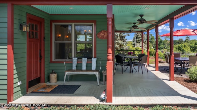 511 County Route 10, Germantown, NY 12526 - wooden deck with outdoor dining area and a ceiling fan