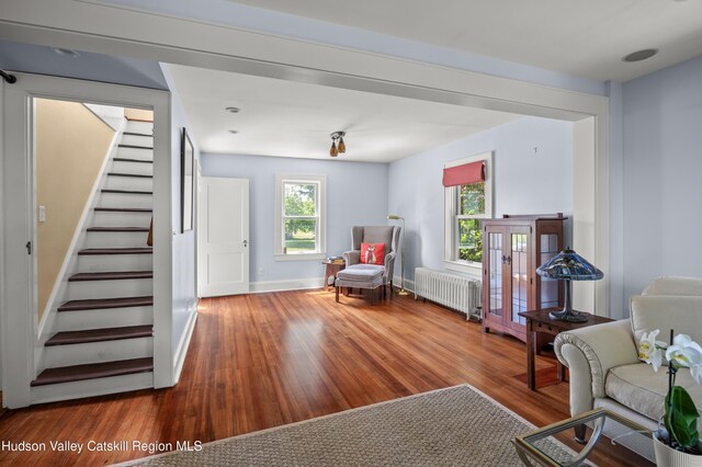 511 County Route 10, Germantown, NY 12526 - living room with radiator, stairs, wood finished floors, and baseboards