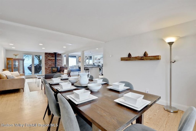 21 Schroon Hill Rd, Kerhonkson, NY 12446 - dining room featuring a wood stove, recessed lighting, baseboards, and light wood finished floors