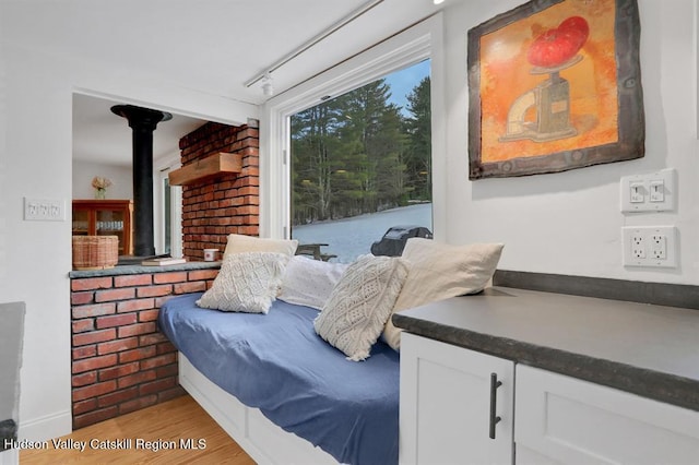21 Schroon Hill Rd, Kerhonkson, NY 12446 - bedroom featuring light wood-style flooring and a wood stove