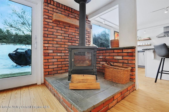 21 Schroon Hill Rd, Kerhonkson, NY 12446 - details with a wood stove, rail lighting, and wood finished floors