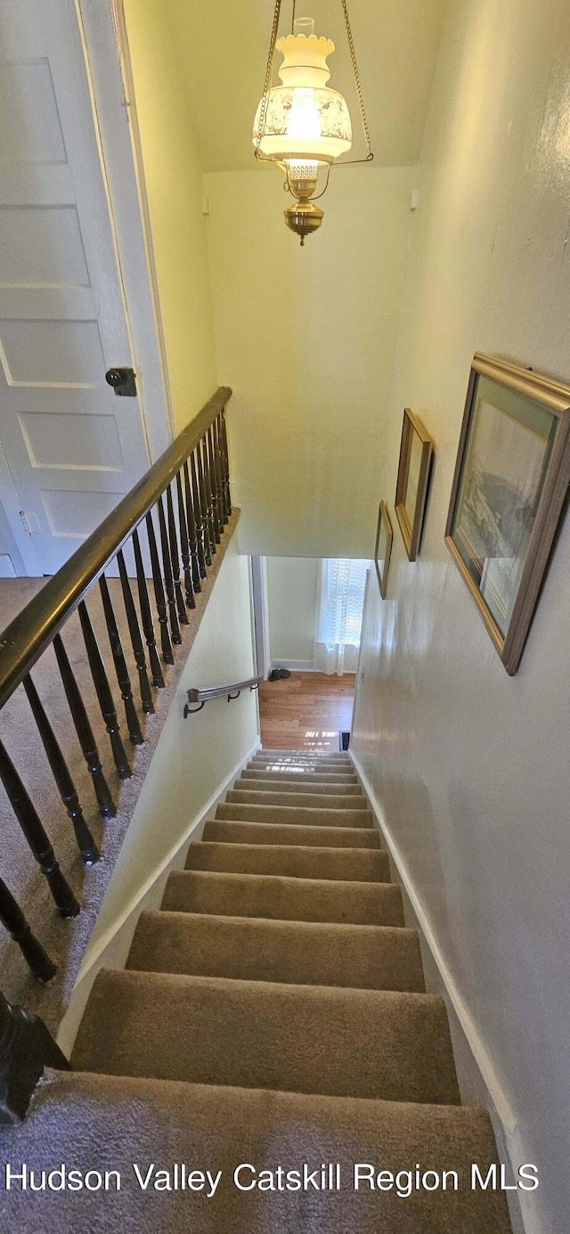 stairs featuring wood-type flooring