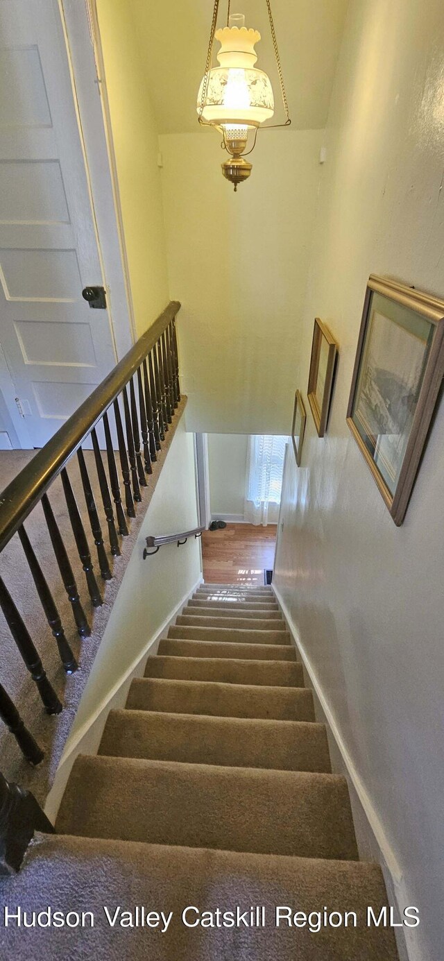 stairs featuring wood-type flooring