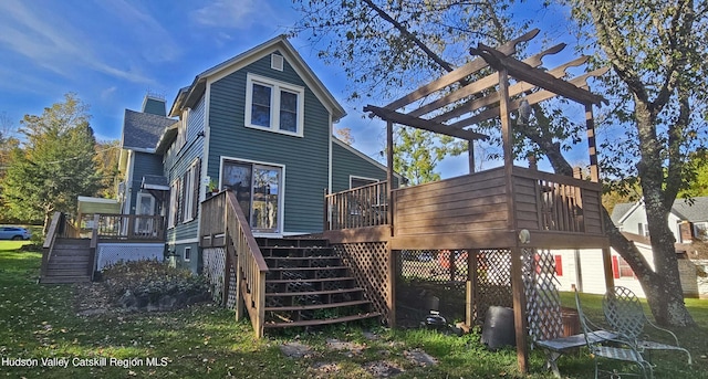 back of house with a pergola, a deck, and a yard