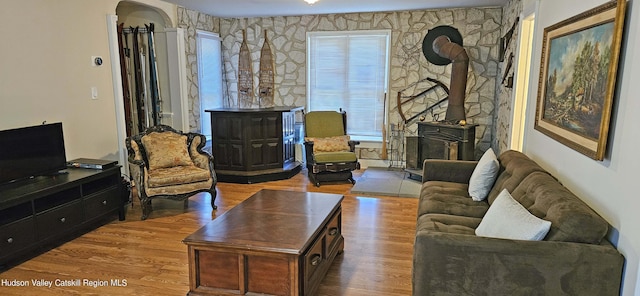 living room featuring a wood stove and light hardwood / wood-style floors