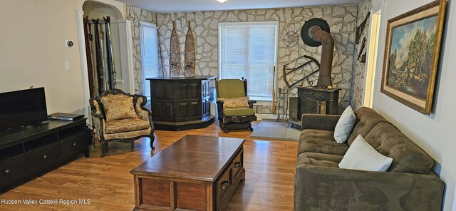 living room featuring a wood stove and light hardwood / wood-style floors