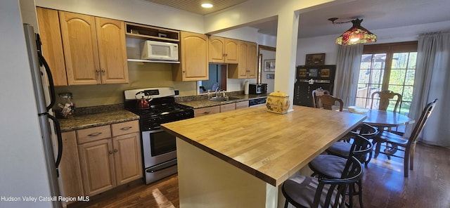 kitchen with wooden counters, dark hardwood / wood-style flooring, white appliances, and a kitchen island