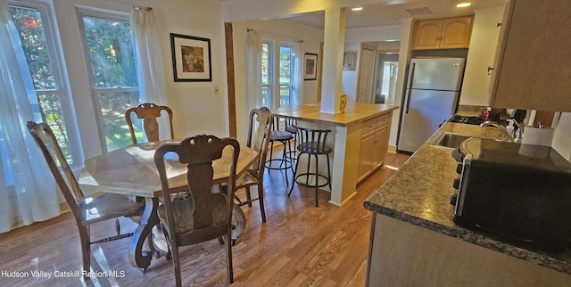 dining room featuring light wood-type flooring and sink