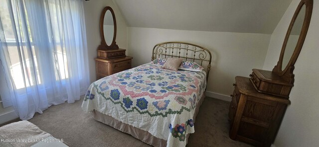 carpeted bedroom featuring vaulted ceiling