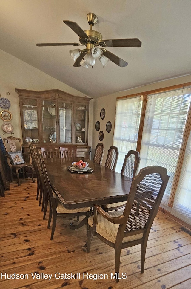 dining area with ceiling fan, light hardwood / wood-style floors, and lofted ceiling