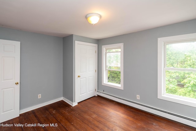 24 Grove St, Cairo, NY 12413 - unfurnished bedroom featuring baseboard heating and dark wood-type flooring