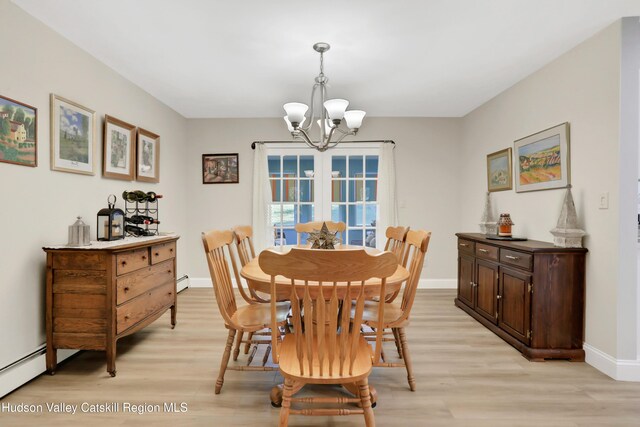 dining space featuring light wood-type flooring, a baseboard radiator, and a notable chandelier