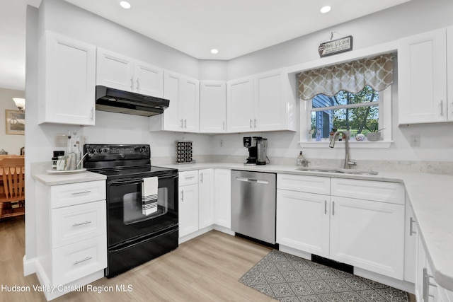 kitchen with stainless steel dishwasher, black range with electric stovetop, sink, light hardwood / wood-style floors, and white cabinetry