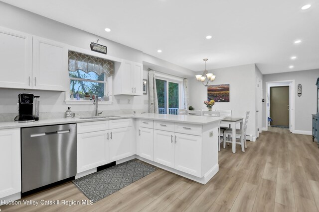 kitchen with white cabinets, dishwasher, pendant lighting, and sink