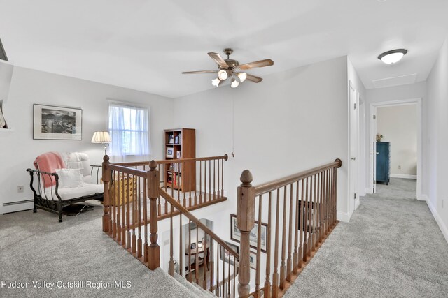 hall with light colored carpet and a baseboard radiator